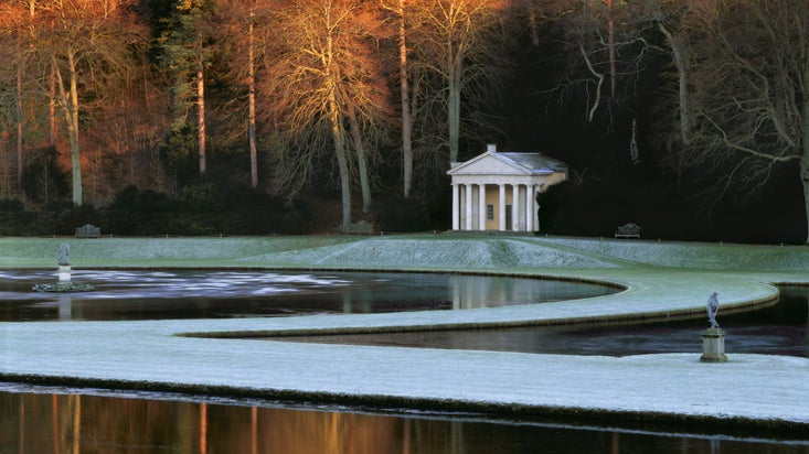 The Temple of Piety seen across the Moon and Half Crescent ponds at Studley Royal Water Garden, North Yorkshire